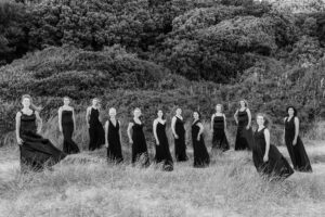 Choir of twelve classical singers in elegant black evening dresses